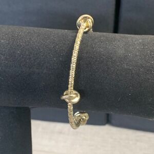 Gold Tone Diamond Cut Textured Bangle Bracelet with Polished Knot Accents 7in